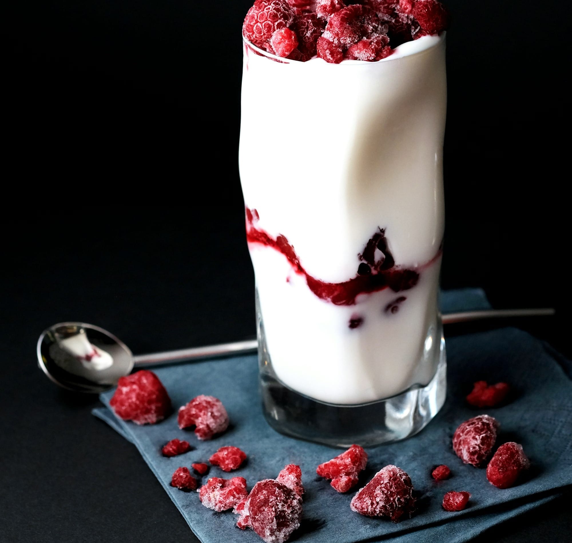 red raspberries on clear drinking glass