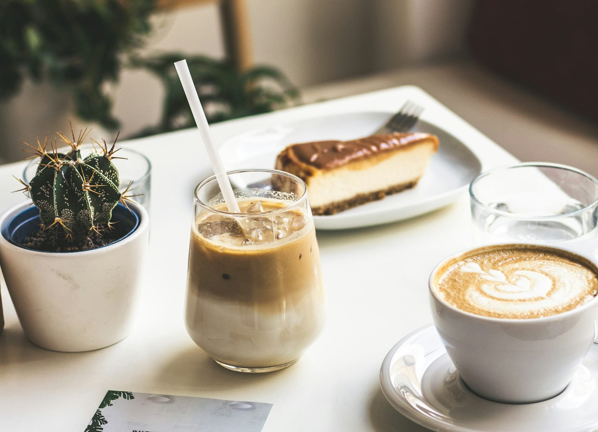 a table topped with a cup of coffee and a plate of food