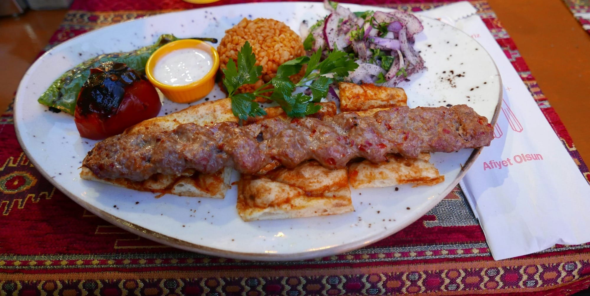 a white plate topped with meat and vegetables